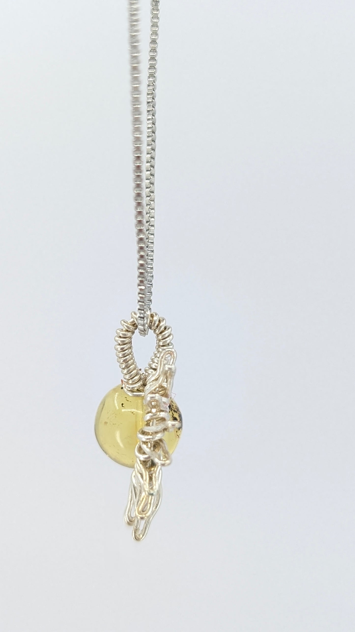 Handcrafted silver-tone half sun pendant necklace with amber center and adjustable chain