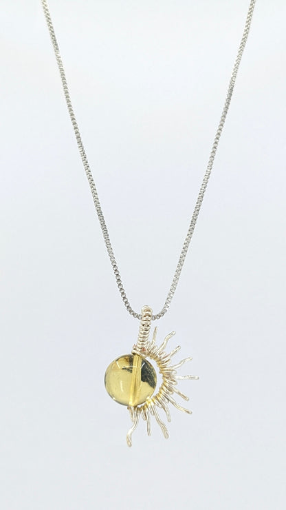 Handcrafted silver-tone half sun pendant necklace with amber center and adjustable chain