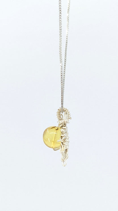 Handcrafted sun pendant necklace with rounded amber center stone on a silver-tone adjustable chain