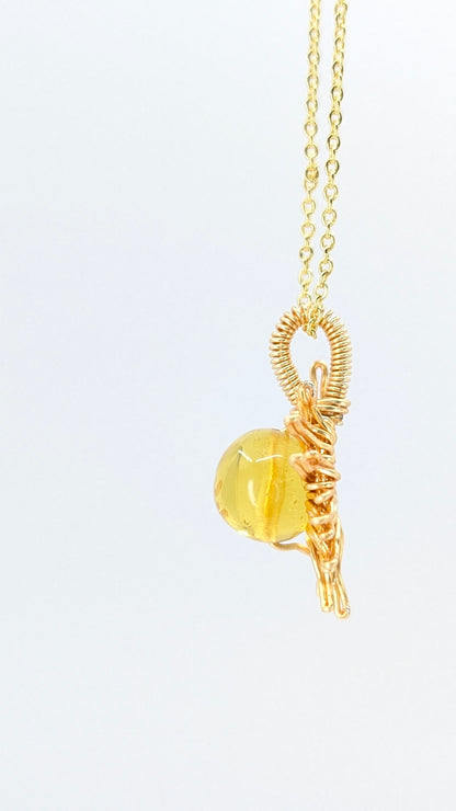 Handcrafted sun pendant necklace with very light amber rounded center stone on an adjustable gold-tone chain