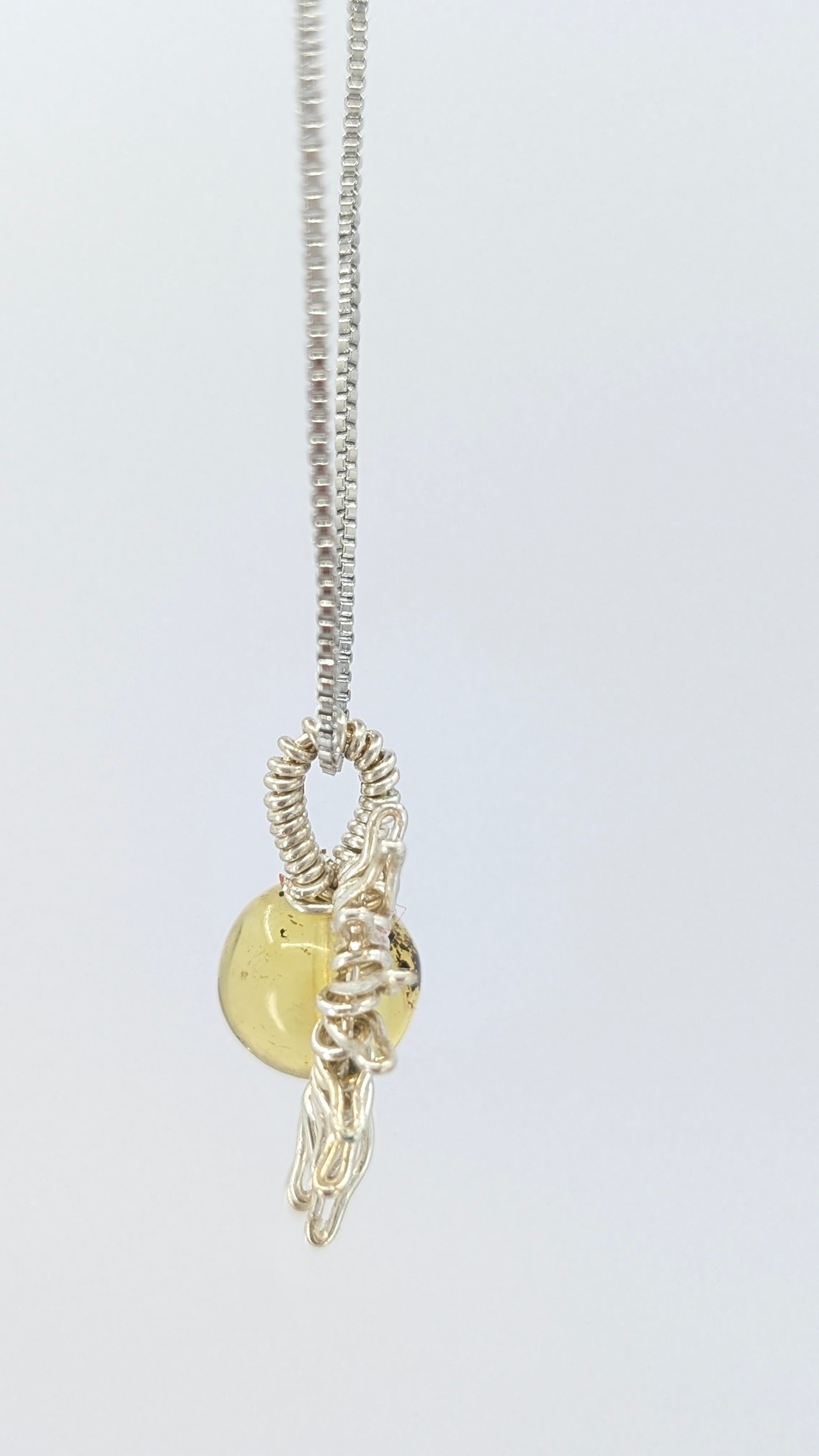 Handcrafted silver-tone half sun pendant necklace with amber center and adjustable chain