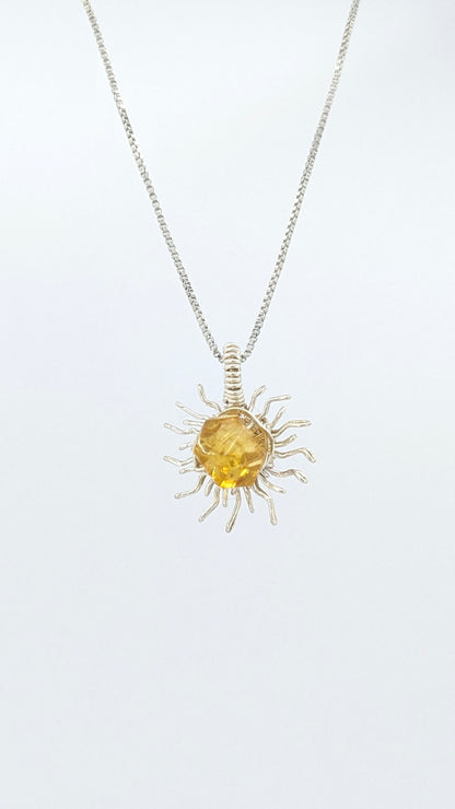 Handcrafted silver-tone sun pendant necklace with amber center stone and adjustable chain