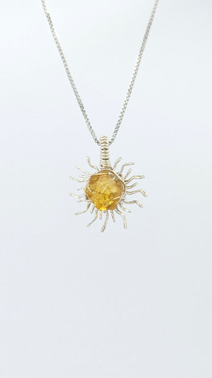 Handcrafted silver-tone sun pendant necklace with amber center stone and adjustable chain