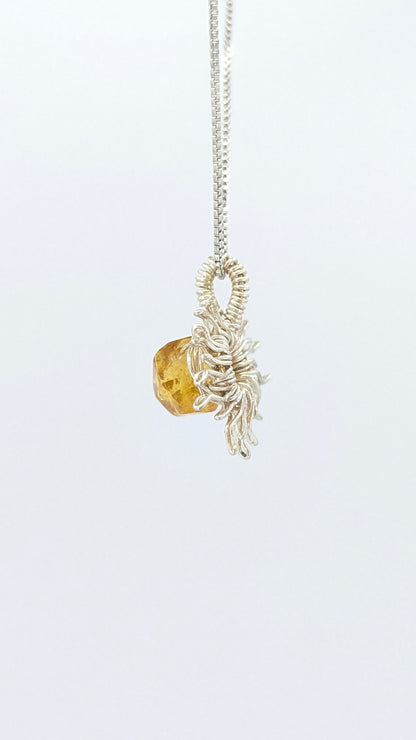 Handcrafted silver-tone sun pendant necklace with amber center stone and adjustable chain