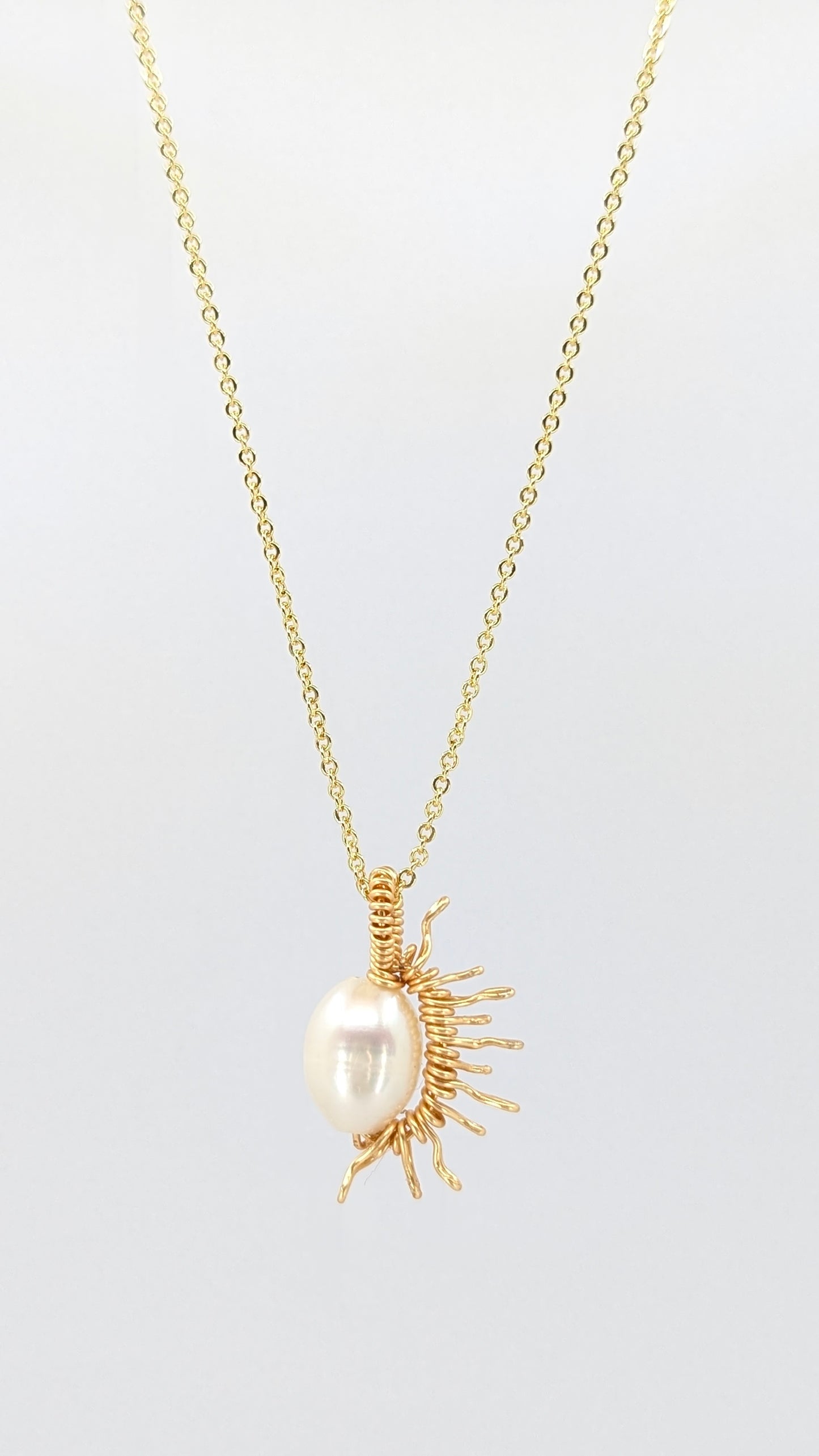 Handcrafted half sun pendant necklace with freshwater pearl on a gold-tone adjustable chain
