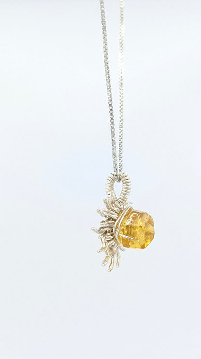 Handcrafted silver-tone sun pendant necklace with amber center stone and adjustable chain
