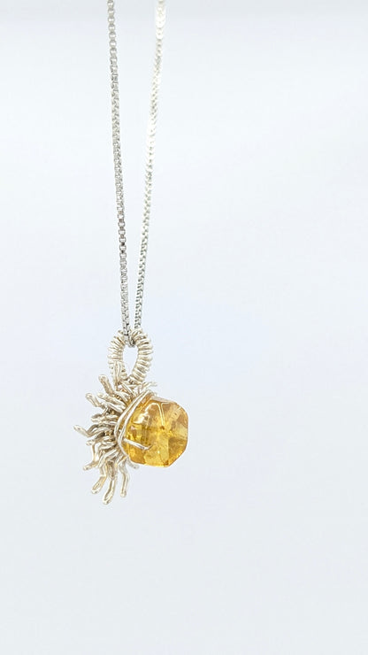 Handcrafted silver-tone sun pendant necklace with amber center stone and adjustable chain