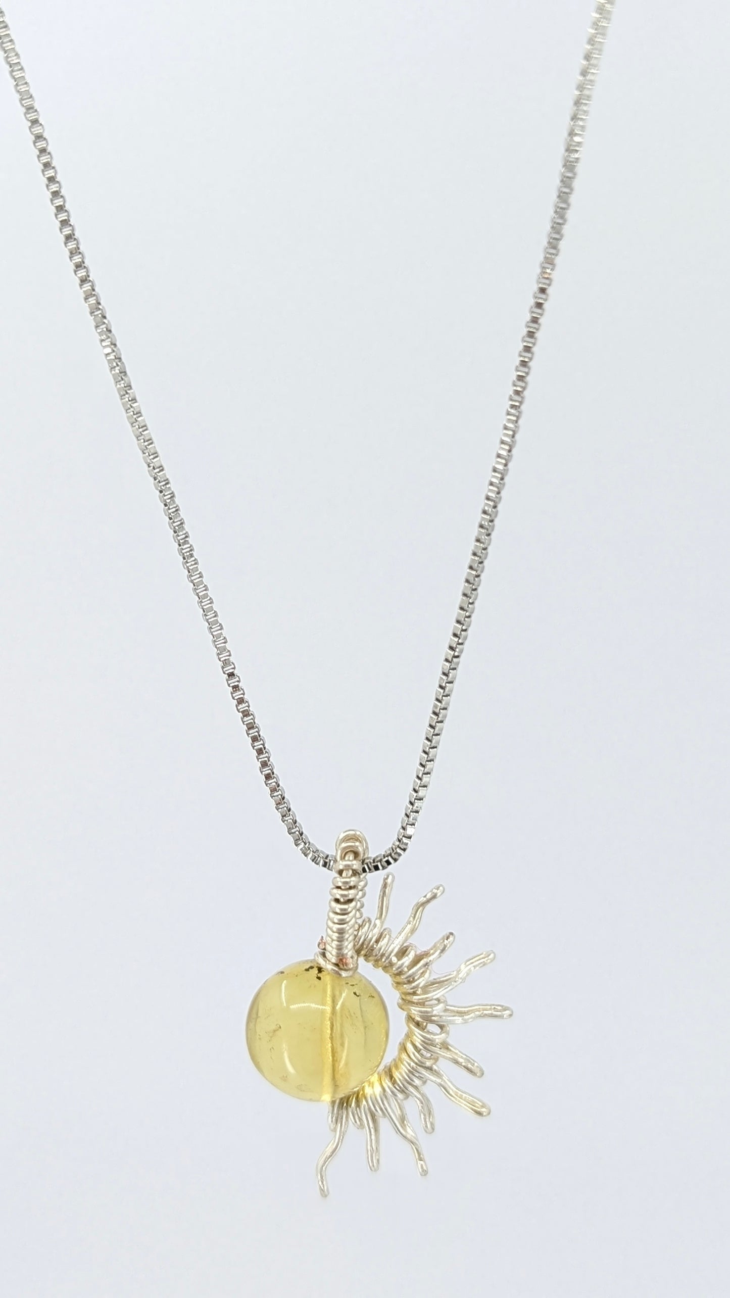 Handcrafted silver-tone half sun pendant necklace with amber center and adjustable chain