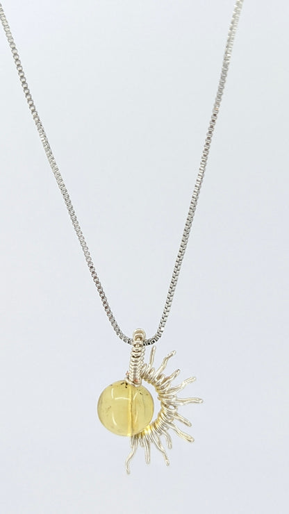 Handcrafted silver-tone half sun pendant necklace with amber center and adjustable chain