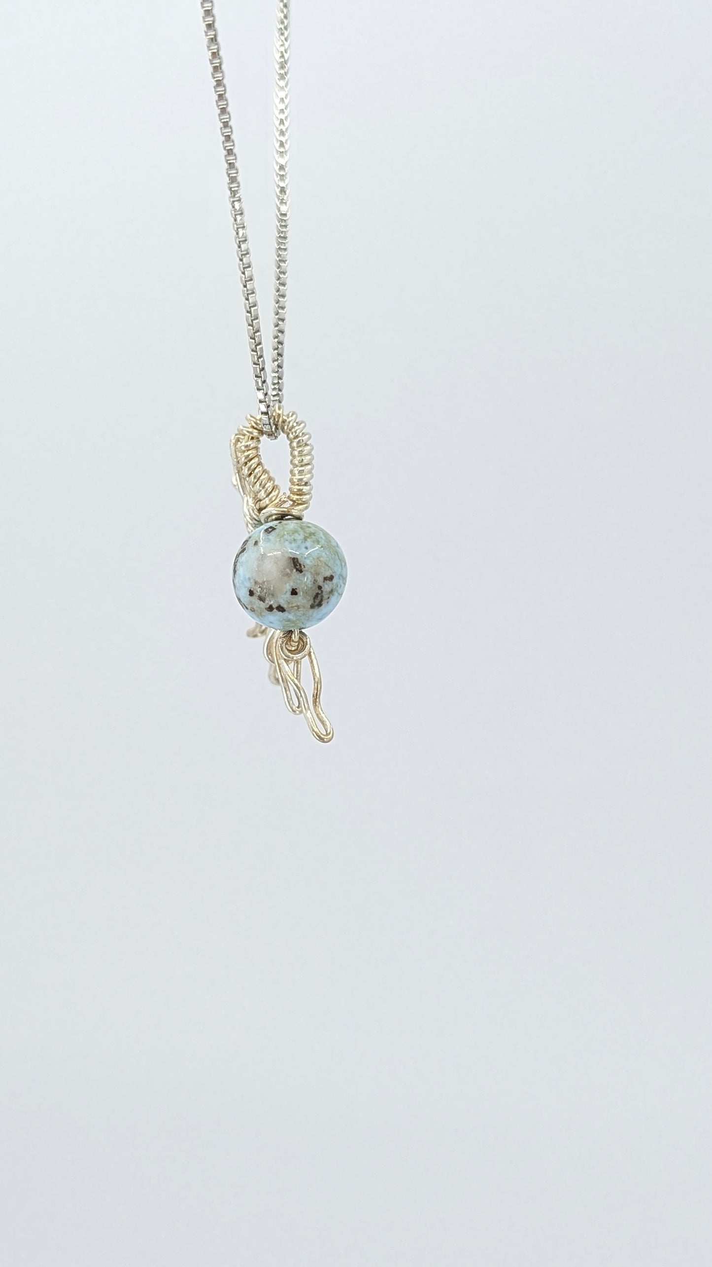 Handcrafted half sun pendant necklace with Larimar stone on a silver-tone adjustable chain.