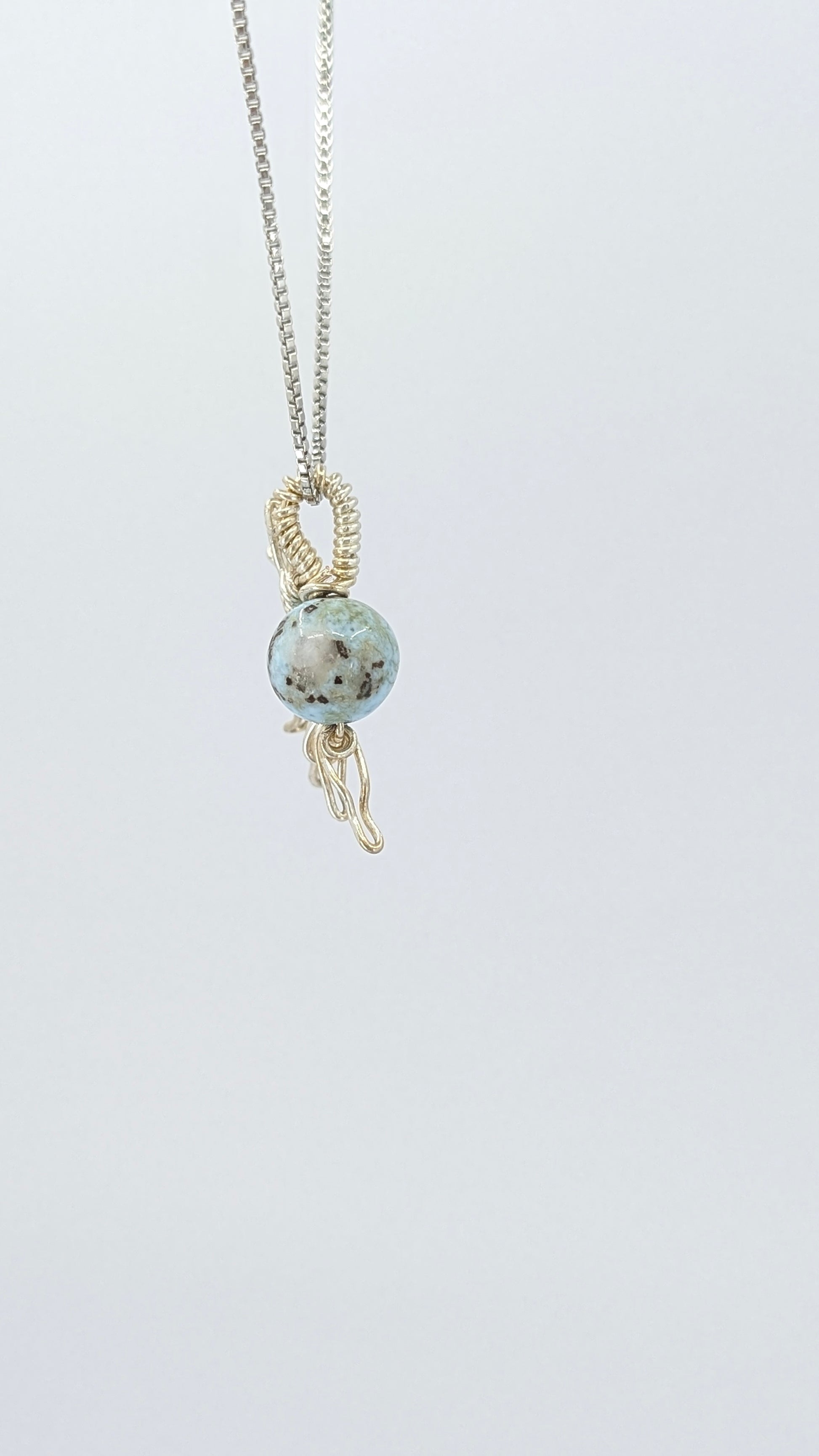 Handcrafted half sun pendant necklace with Larimar stone on a silver-tone adjustable chain.