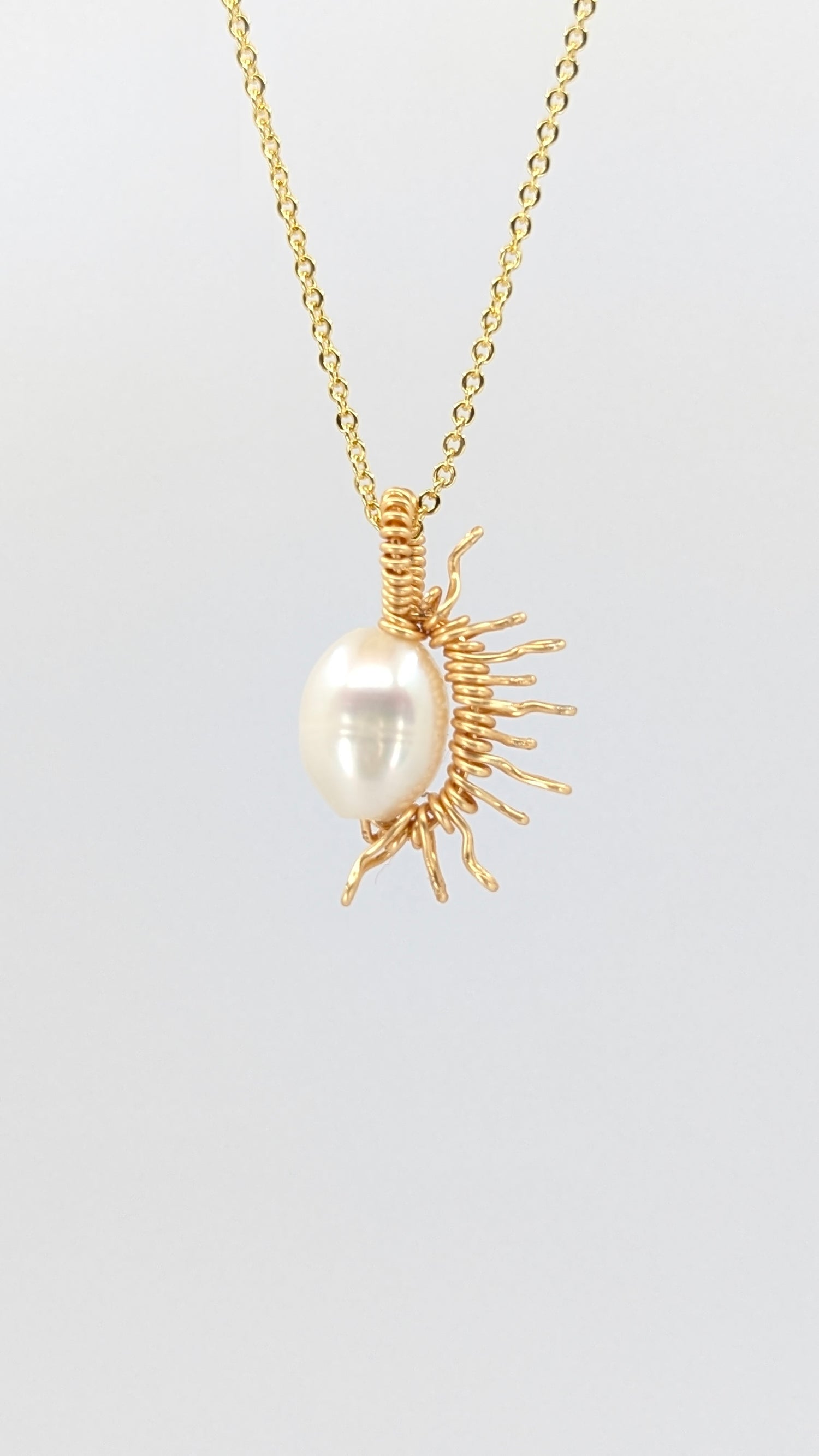 Handcrafted half sun pendant necklace with freshwater pearl on a gold-tone adjustable chain