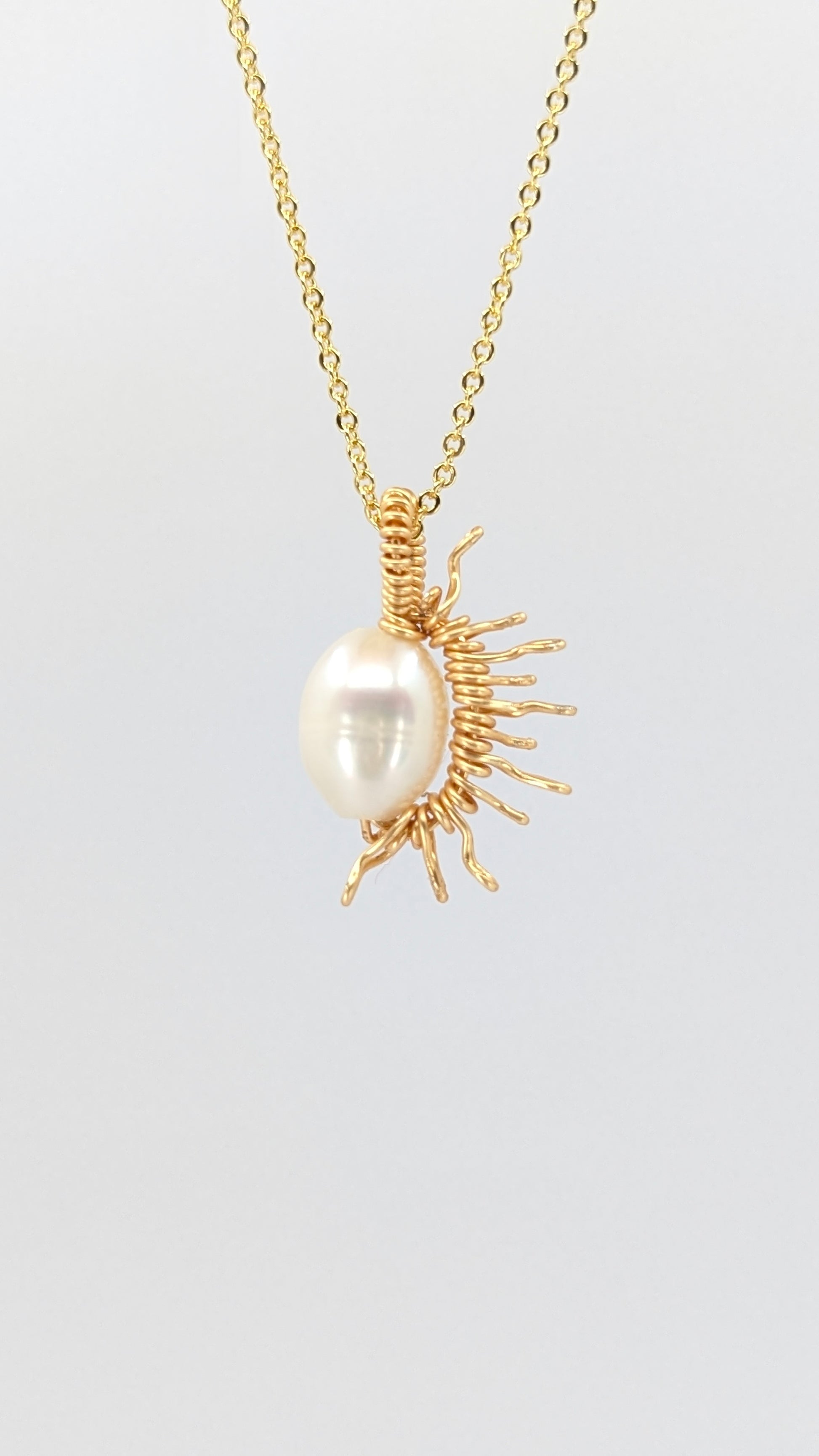 Handcrafted half sun pendant necklace with freshwater pearl on a gold-tone adjustable chain