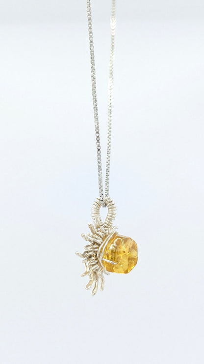 Handcrafted silver-tone sun pendant necklace with amber center stone and adjustable chain