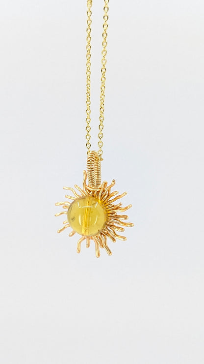 Handcrafted sun pendant necklace with very light amber rounded center stone on an adjustable gold-tone chain