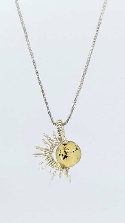Handcrafted silver-tone half sun pendant necklace with amber center and adjustable chain