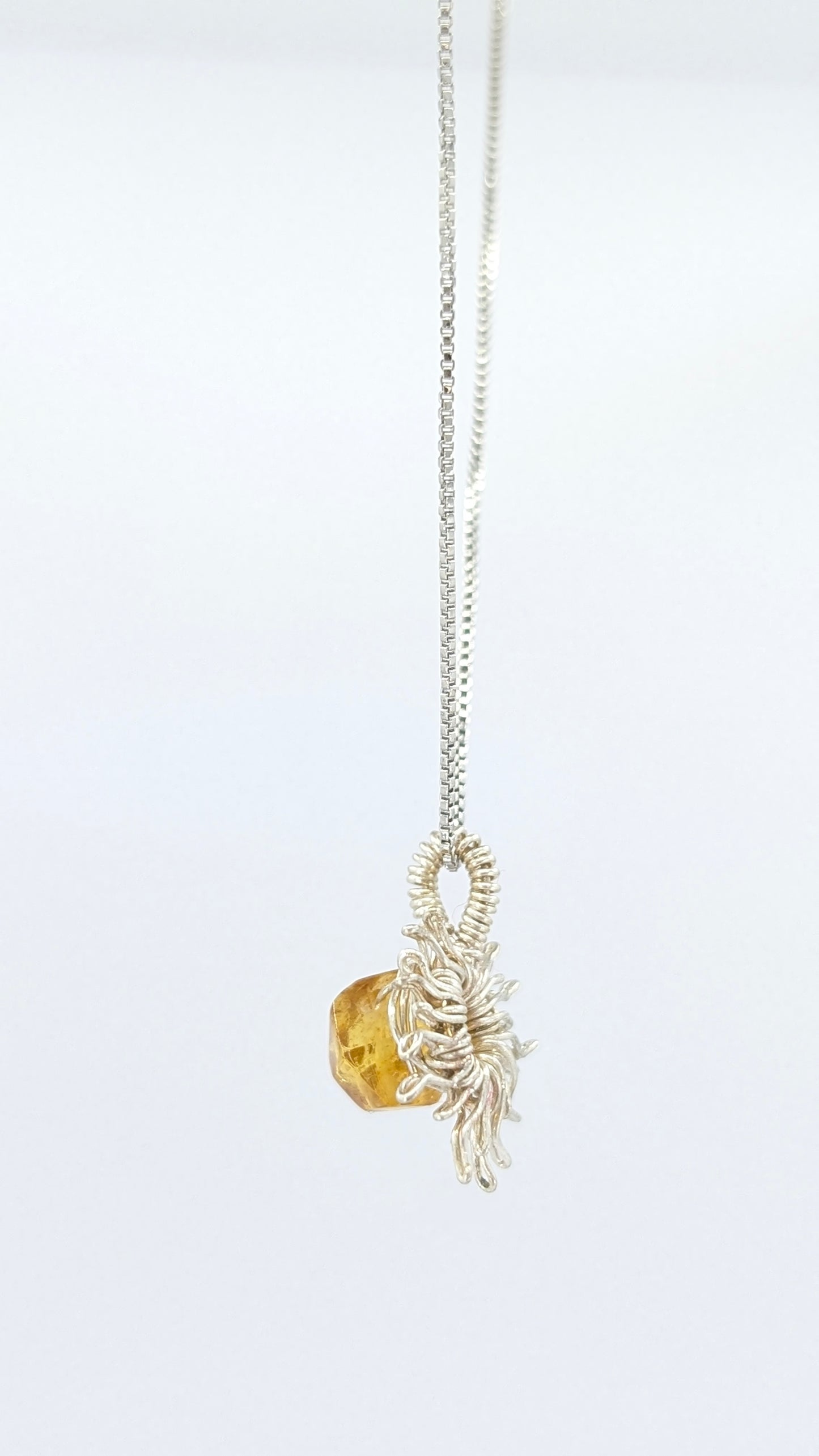 Handcrafted silver-tone sun pendant necklace with amber center stone and adjustable chain
