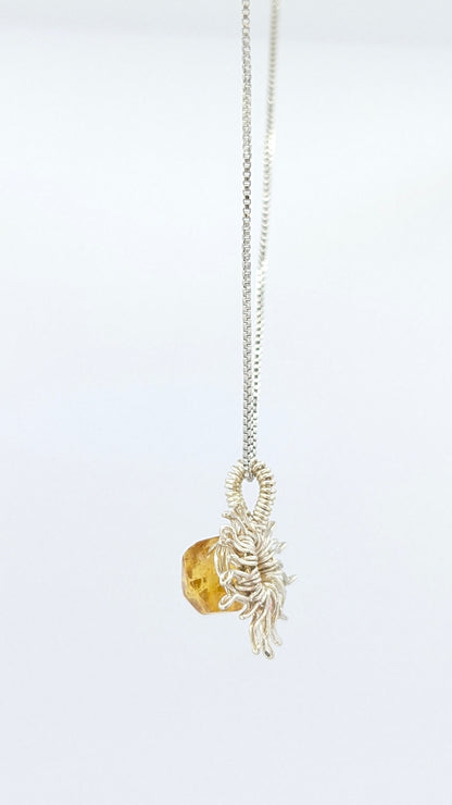 Handcrafted silver-tone sun pendant necklace with amber center stone and adjustable chain